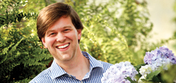 College of Agriculture alumnus, James T. Farmer III holds a bucket of blue hydrangeas.